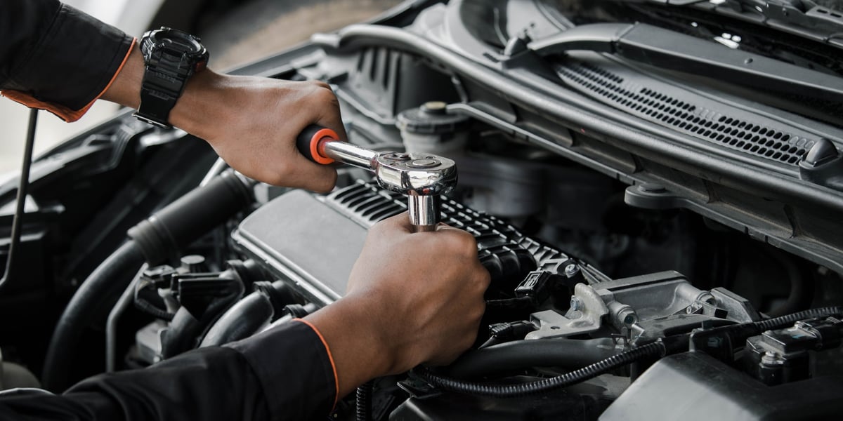 Mechanic performing car repair at night